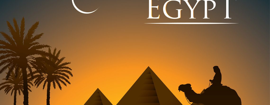 Silhouette of pyramids and camel at sunset in Egypt.