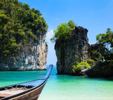 Scenic tropical beach with turquoise water and traditional boat