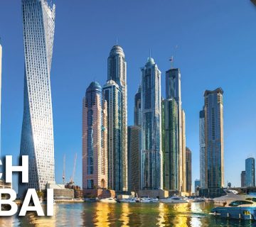 Dubai Marina skyline with modern skyscrapers and yachts.