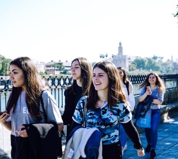 Group of young people walking outdoors on a sunny day 