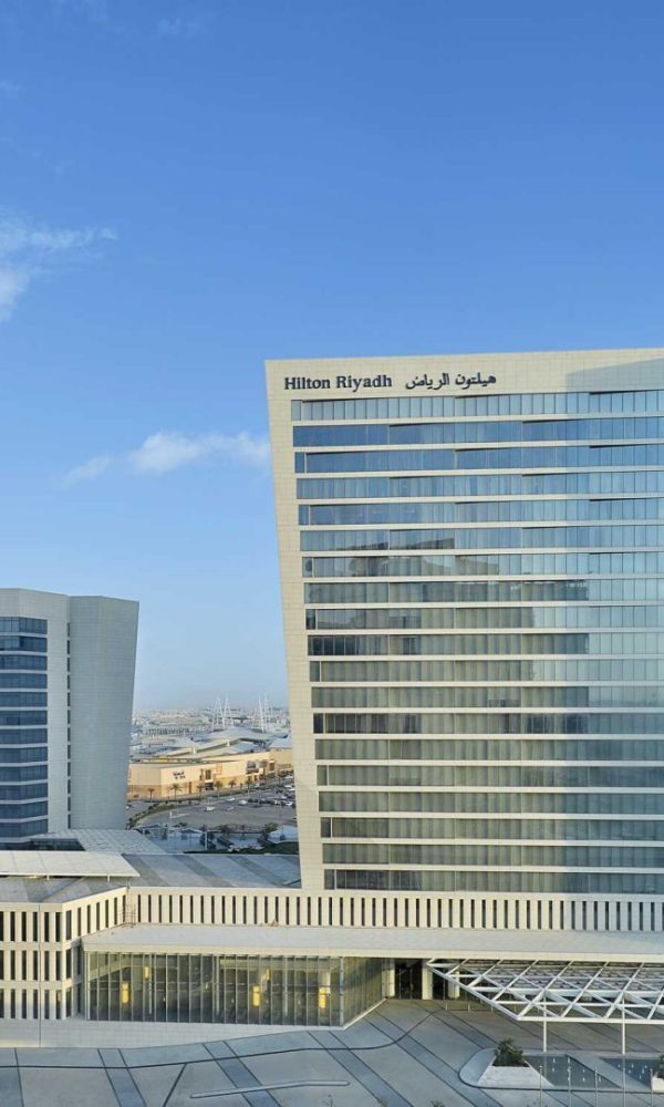 Modern Hilton Riyadh hotel with glass facade under blue sky