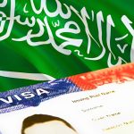 Saudi Arabian flag with a visa document in the foreground.